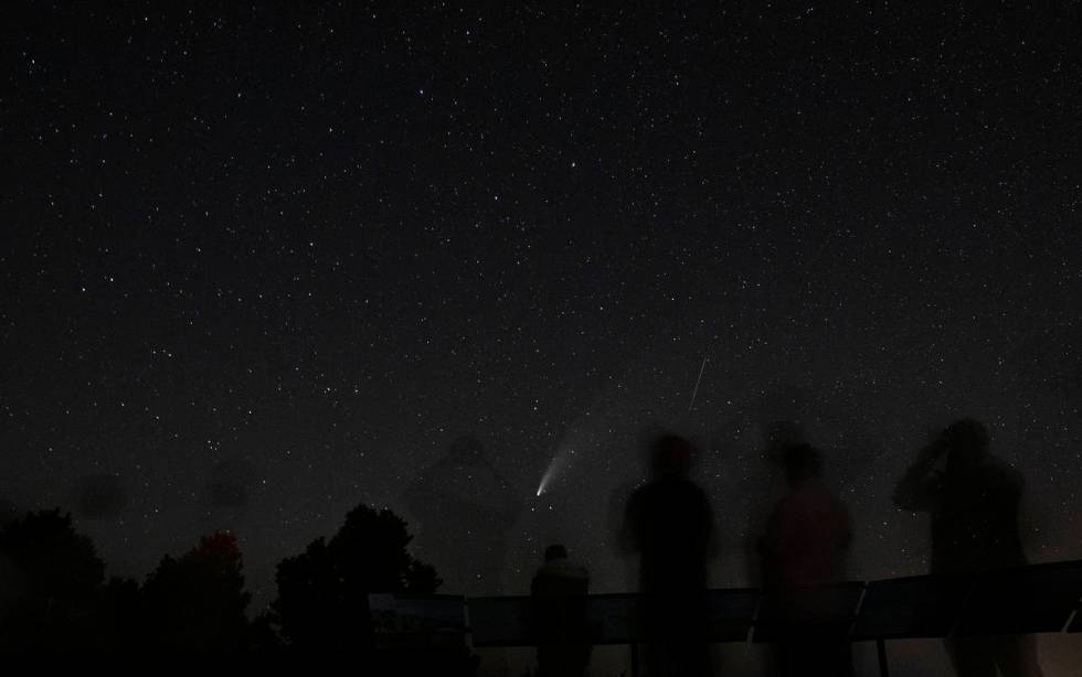 Viewers of the NEOWISE comet watch as it is visible to the naked eye for the last evening on Sa ...