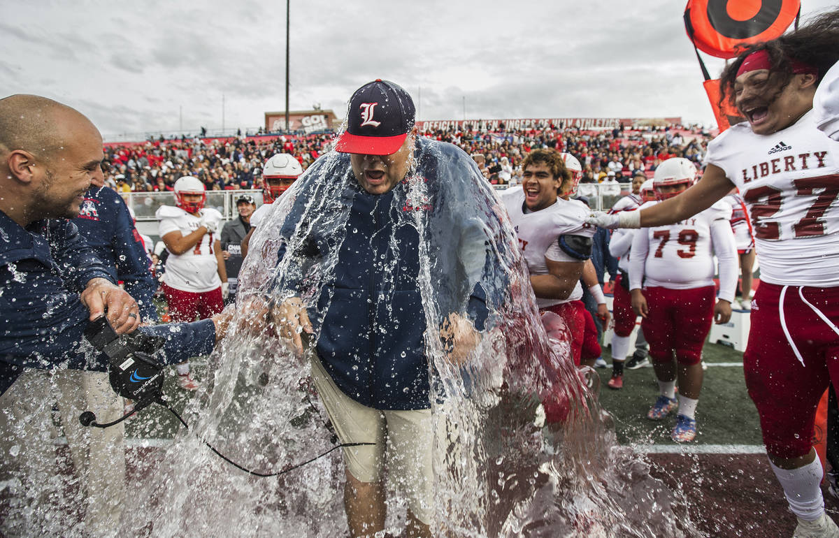 Liberty coach Rich Muraco is given a Gatorade bath after defeating Centennial 50-7 to win the C ...