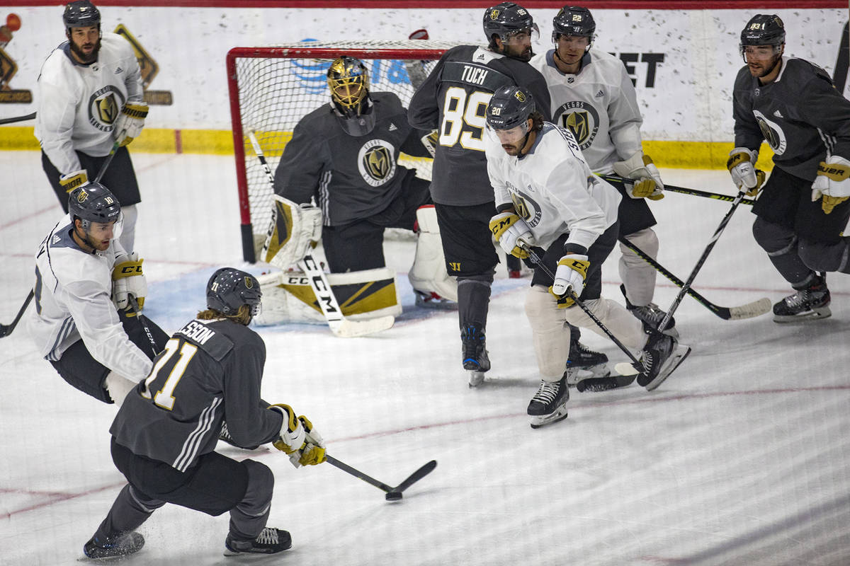 Golden Knights' William Karlsson (71), attempts a goal past fellow player Chandler Stephenson ( ...