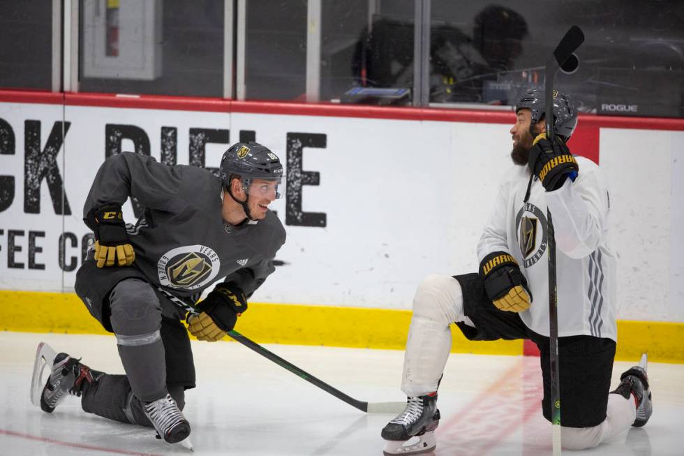 Golden Knights' defenseman Nate Schmidt (88) stretches with defenseman Deryk Engelland (5) duri ...