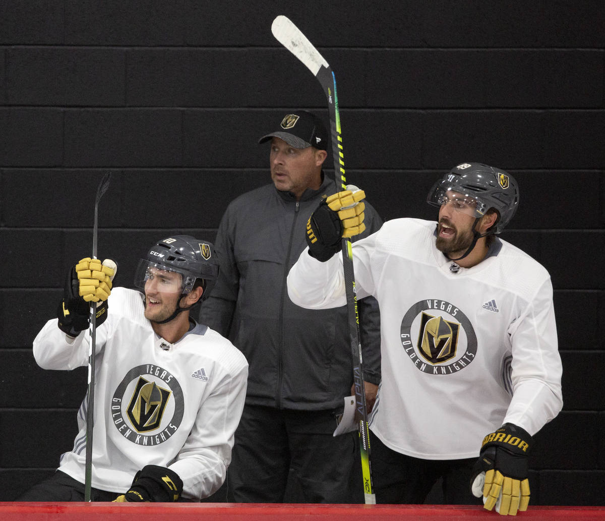 Golden Knights' forward Nicolas Roy (10), assistant coach Steve Spott, center, and forward Alex ...