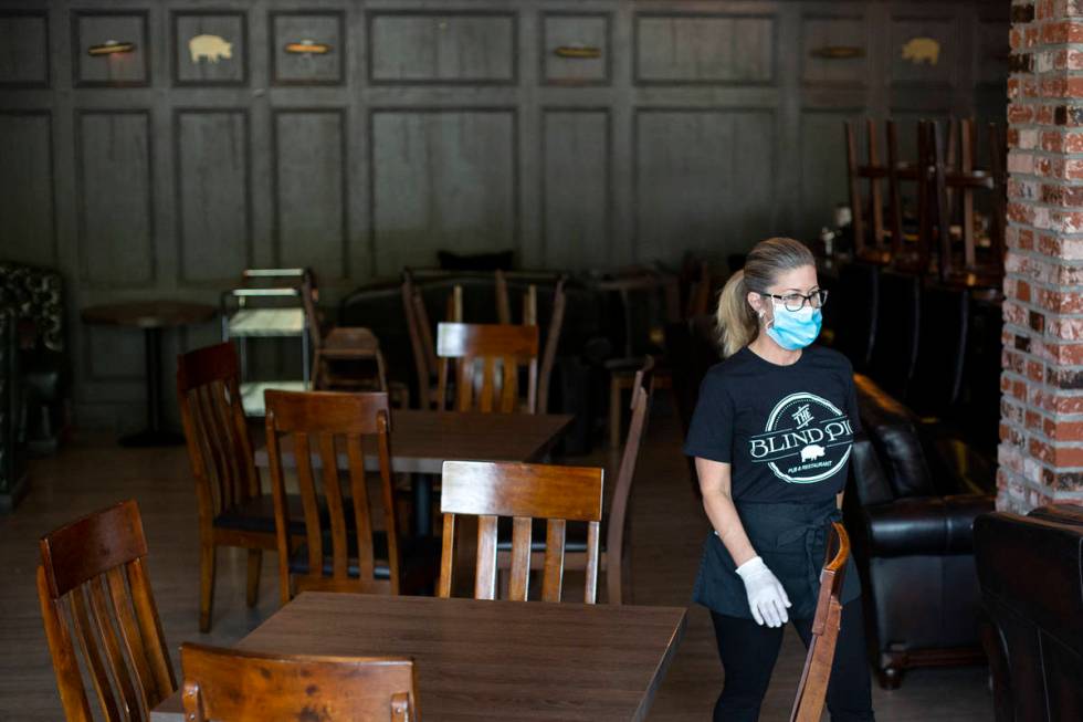 Tonya Blomgren returns from helping a customer at The Blind Pig on Monday, July 20, 2020, in La ...