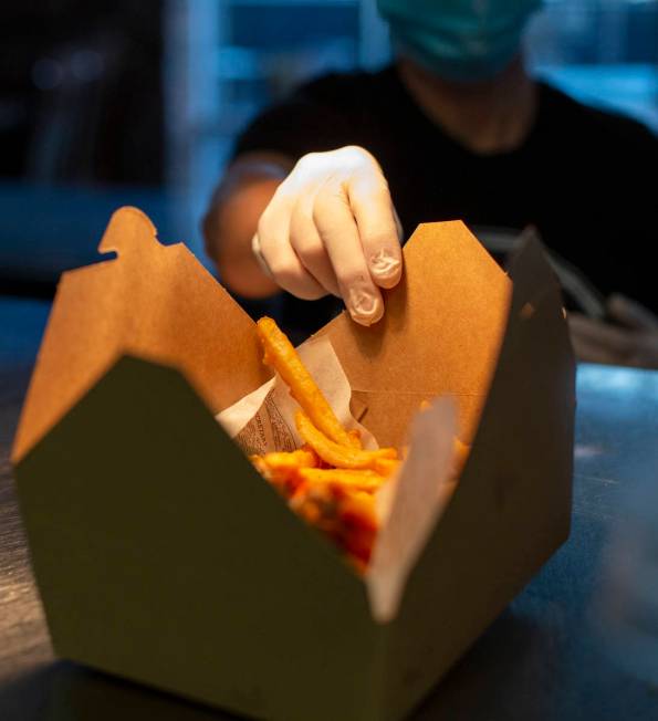 Tonya Blomgren packages to-go food at The Blind Pig on Monday, July 20, 2020, in Las Vegas. The ...