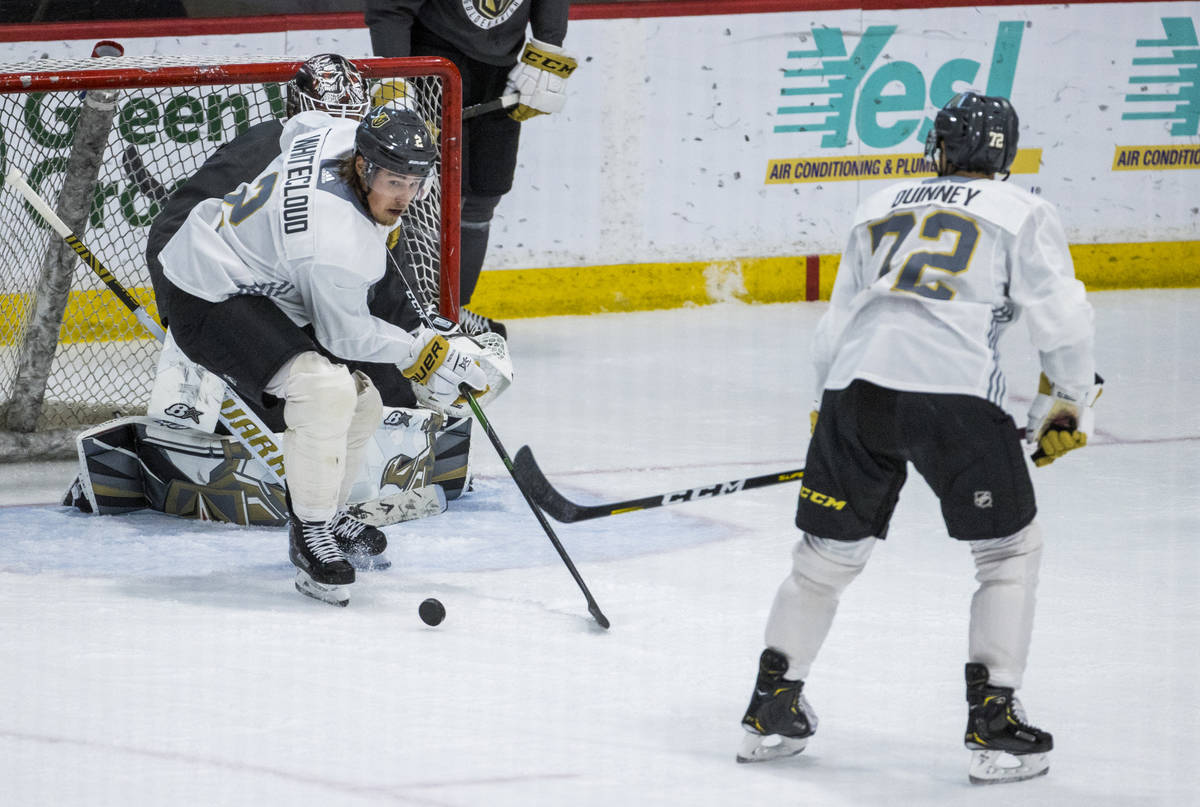 Vegas Golden Knights defenseman Zach Whitecloud (2, left) defends the net over forward Gage Qui ...