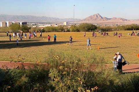 Children play flag football on the field behind Reunion Trails Park Thursday, Oct. 26, 2017, in ...
