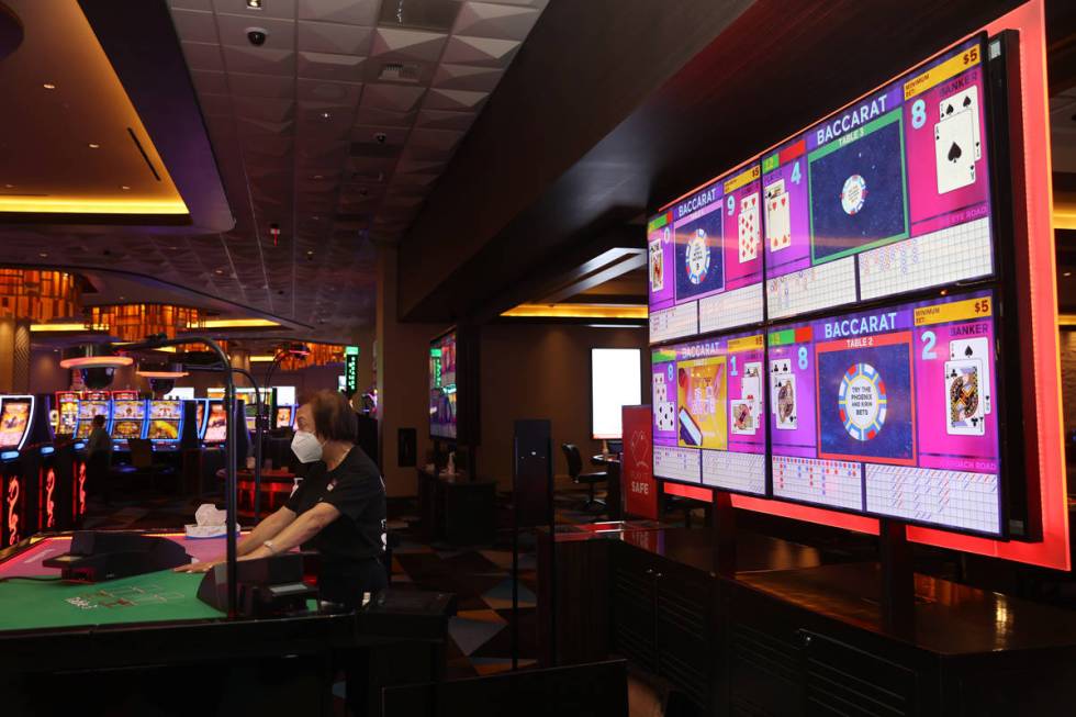 Table game dealer Annie Sit deals cards during a game of baccarat at Palace Station Casino in L ...