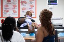 Butcher Mike Lawson, middle, takes a customers order at Mario's Westside Market on Wednesday, J ...