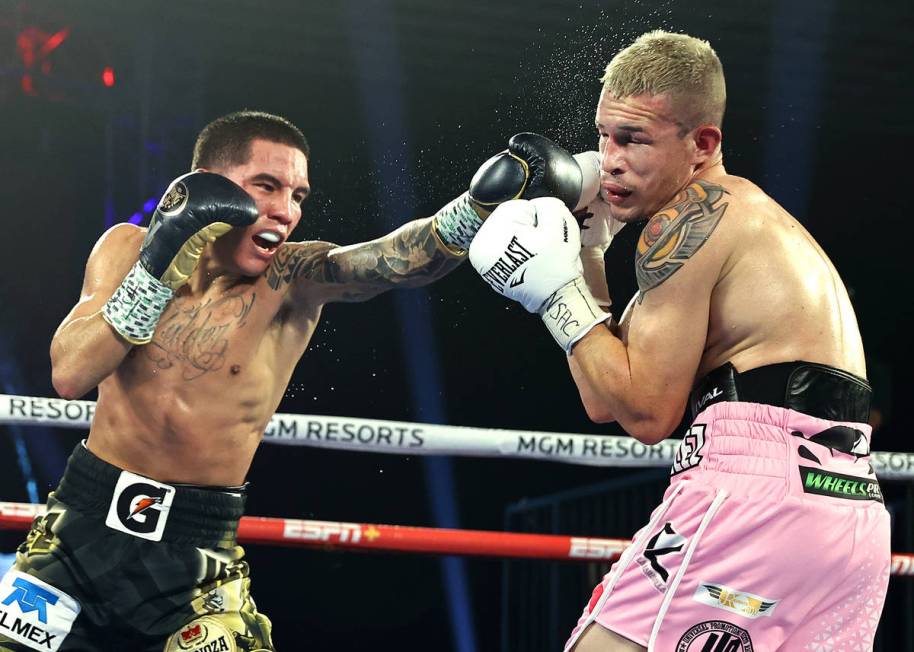 Oscar Valdez, left, connects with a punch against Jayson Velez during their junior lightweight ...