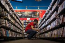 An employee works a movie section at a Vintage Stock store in Kansas City, Missouri. Vintage St ...