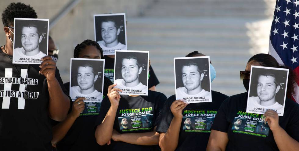 People hold Jorge Gomez's photos up during a news conference on Wednesday, July 22, 2020, in La ...
