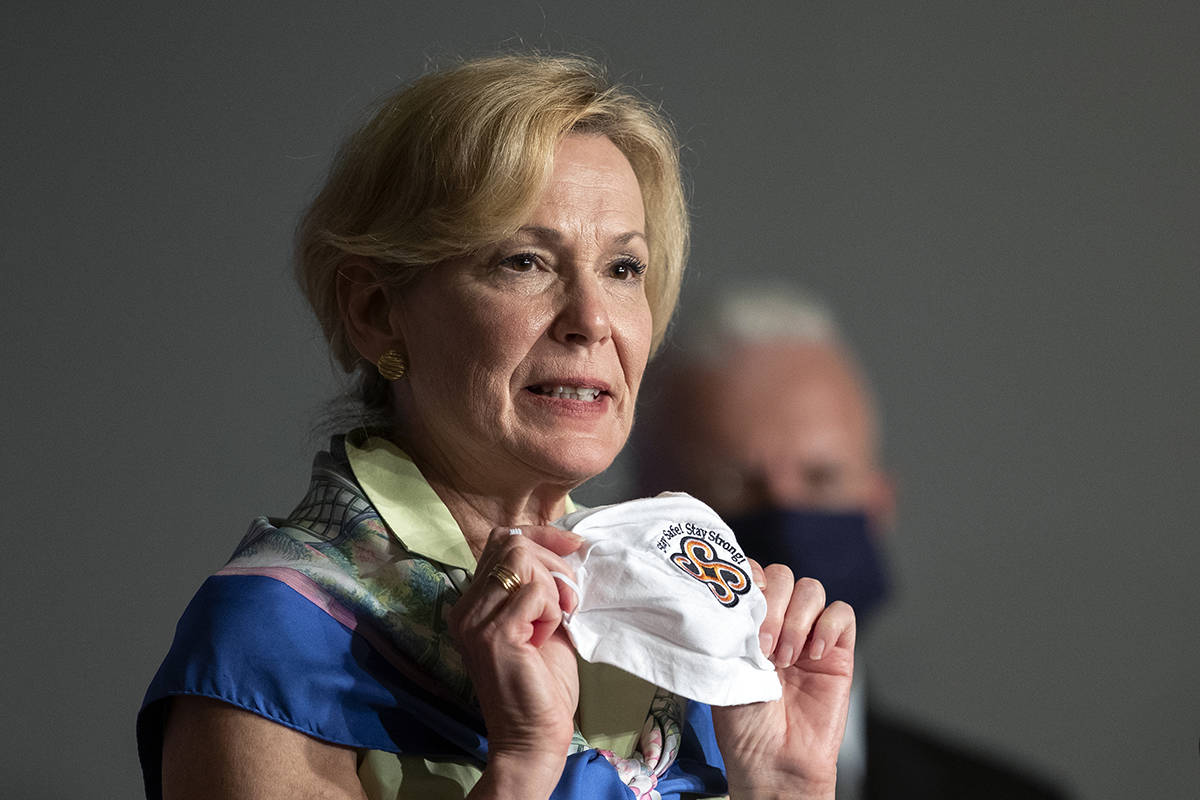 White House coronavirus response coordinator Dr. Deborah Birx holds her face mask as she speaks ...