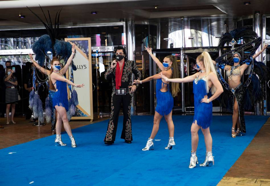 Brendan Paul, impersonating Elvis Presley, addresses the crowd alongside dancers at the reopeni ...