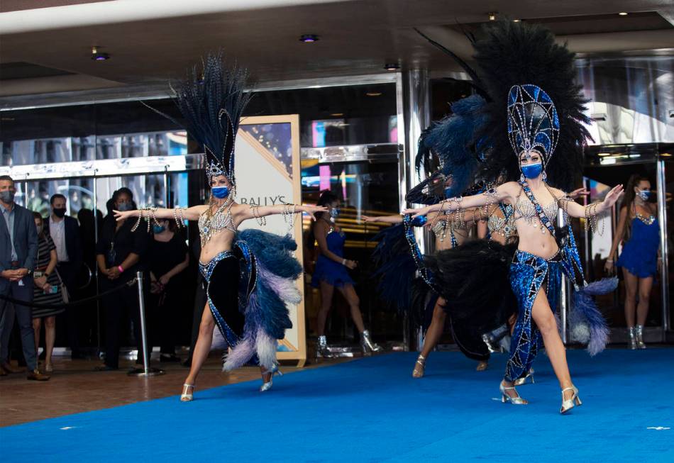 Dancers perform at the reopening of Bally's casino after a months long closure due to the coron ...