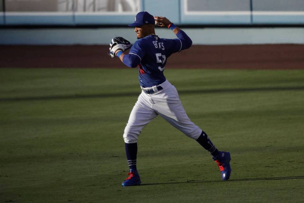 Los Angeles Dodgers right fielder Mookie Betts throws after catching a fly ball during the firs ...