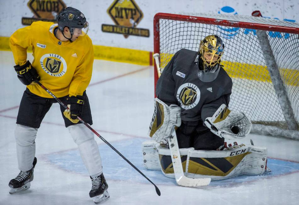 Vegas Golden Knights left wing Tomas Nosek (92, left) has a deflection on goal stopped by goalt ...