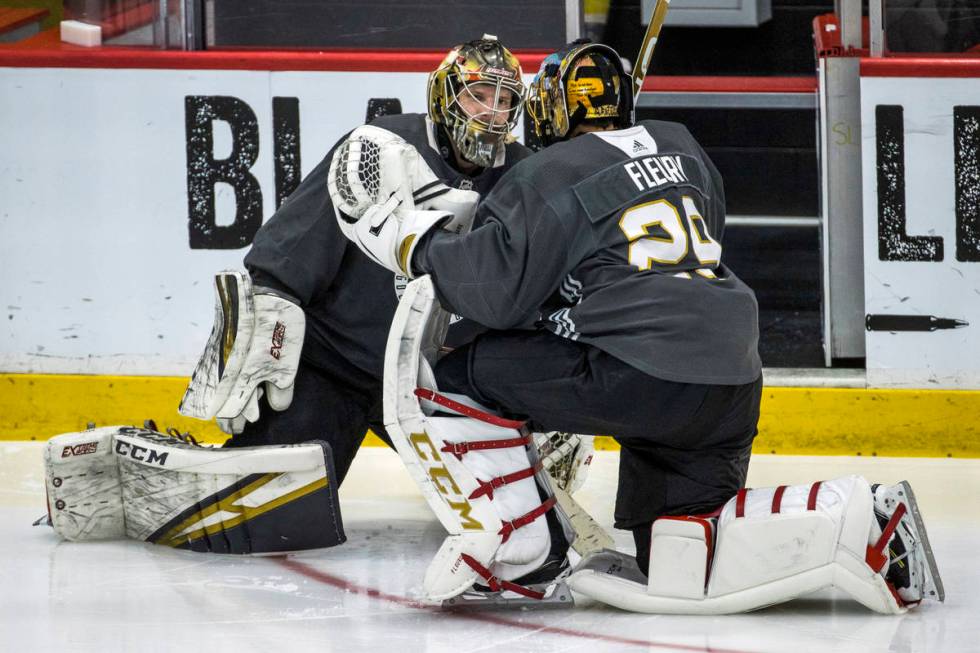 Vegas Golden Knights goaltender Marc-Andre Fleury (29, right) chats with goaltender Oscar Dansk ...