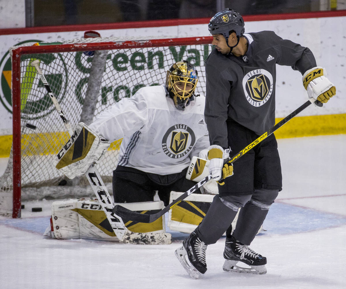 Vegas Golden Knights right wing Ryan Reaves (75, right) deflects a shot towards the net and goa ...