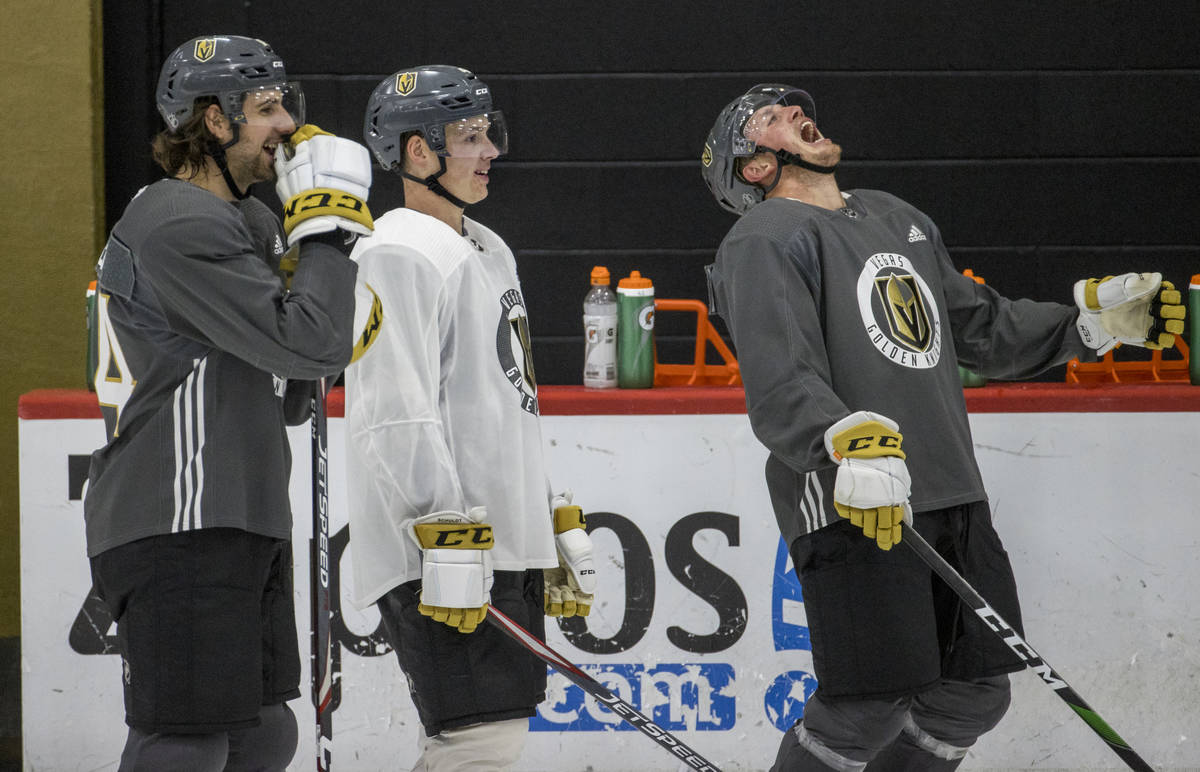 Vegas Golden Knights defenseman Nate Schmidt (88, right) laughs heartily as defenseman Jimmy Sc ...