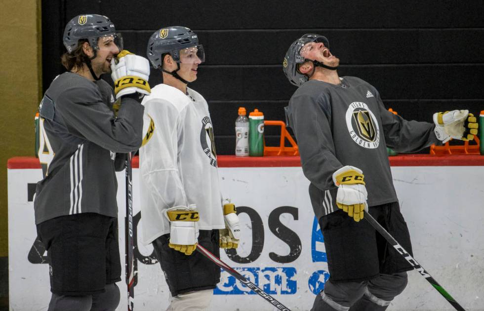 Vegas Golden Knights defenseman Nate Schmidt (88, right) laughs heartily as defenseman Jimmy Sc ...