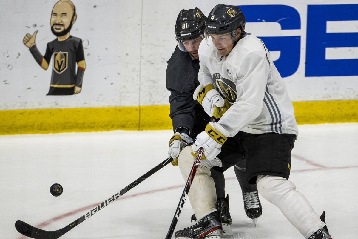 Vegas Golden Knights center Jonathan Marchessault (81, left) battles for control of the puck wi ...