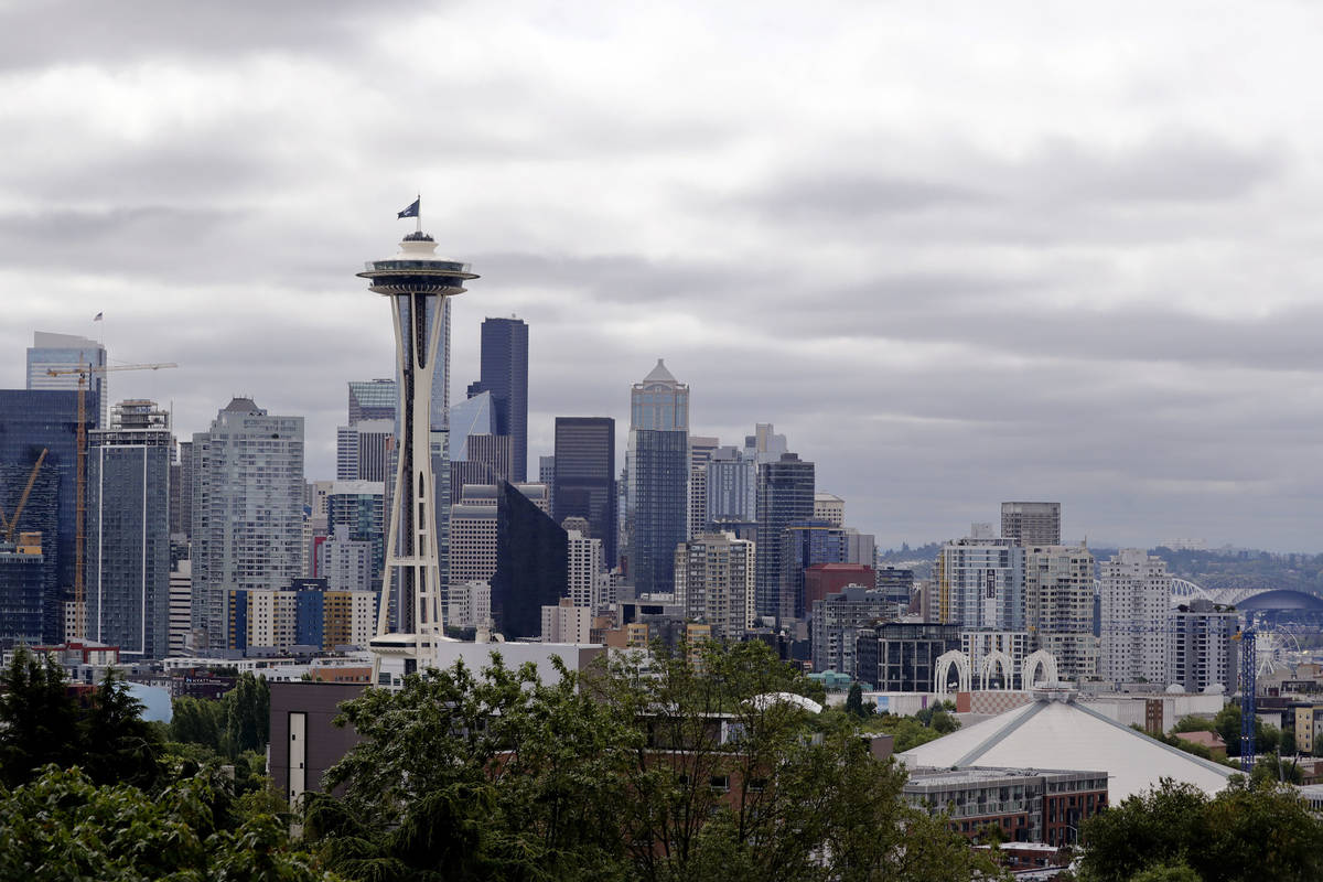 A flag with the new logo for the newly-named Seattle NHL hockey team, the Seattle Kraken, flies ...