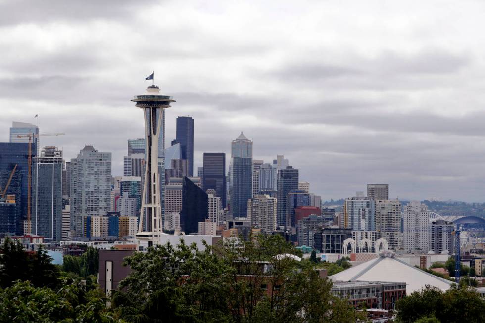 A flag with the new logo for the newly-named Seattle NHL hockey team, the Seattle Kraken, flies ...