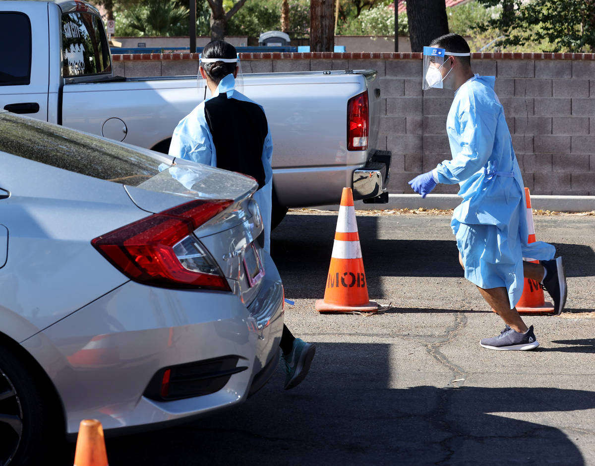 UNLV Medicine certified medical assistants and Nevada National Guard members test curbside for ...