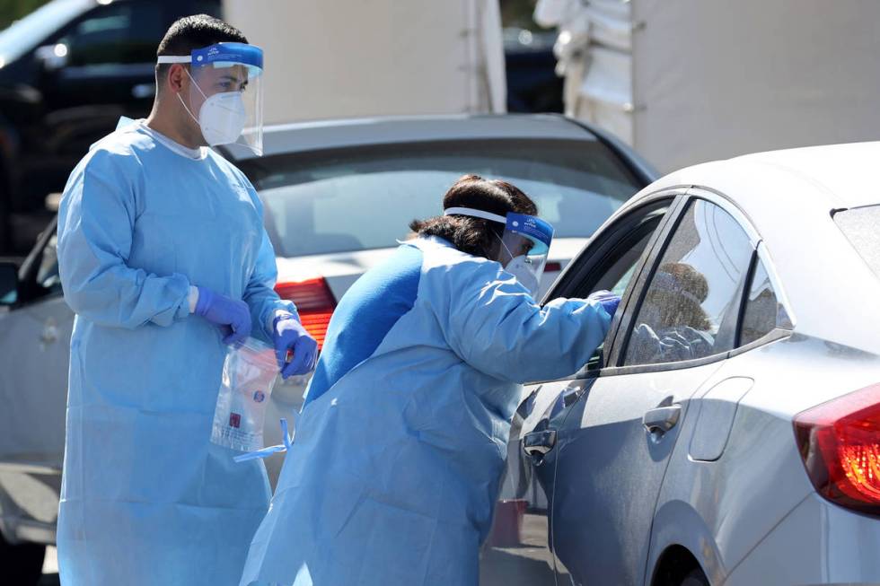 UNLV Medicine certified medical assistants and Nevada National Guard members test curbside for ...