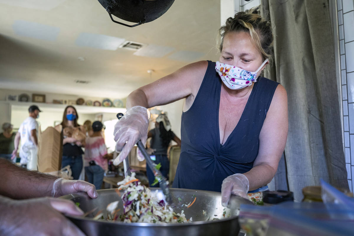 Food writer and lead organizer of Please Send Noodles Kim Foster prepares coleslaw for a side d ...