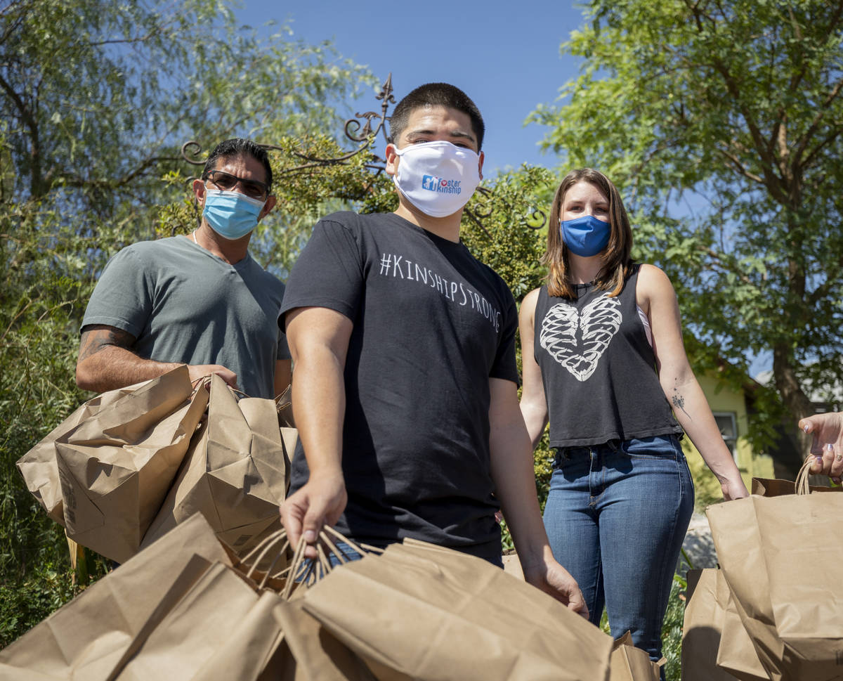 Chef Luke Palladino, left, Foster Kinship operations manager Gustavo Mota, center, and Please S ...