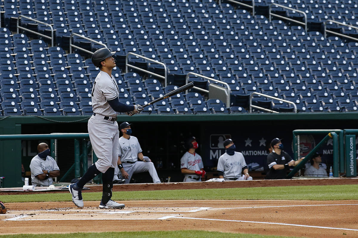 New York Yankees' Giancarlo Stanton watches his two-run home run during the first inning of an ...