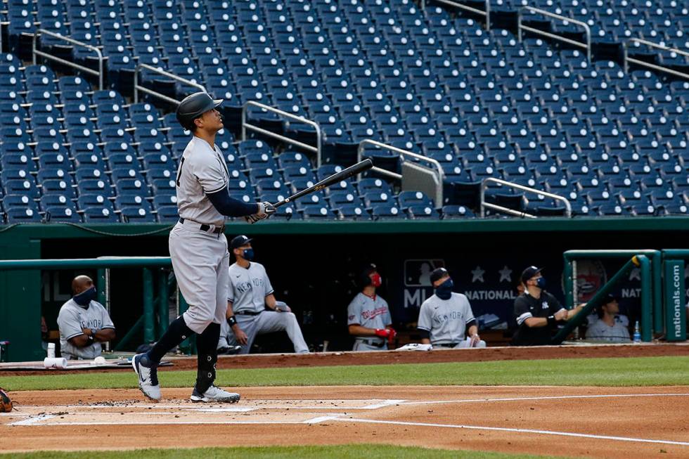 New York Yankees' Giancarlo Stanton watches his two-run home run during the first inning of an ...