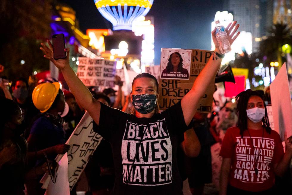 Leinati Hackley raises her hands during a Black Lives Matter march on the Las Vegas Strip on Sa ...