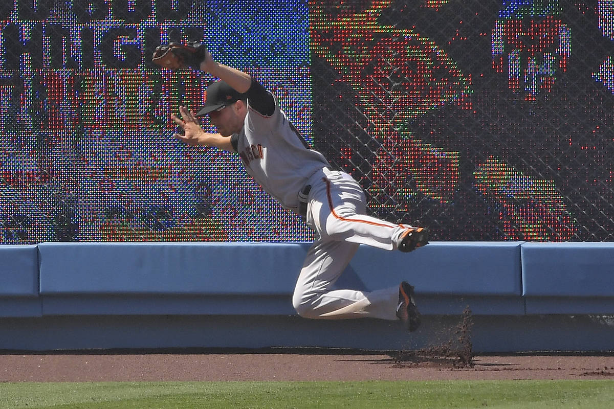 San Francisco Giants left fielder Austin Slater makes a catch on a ball hit by Los Angeles Dodg ...
