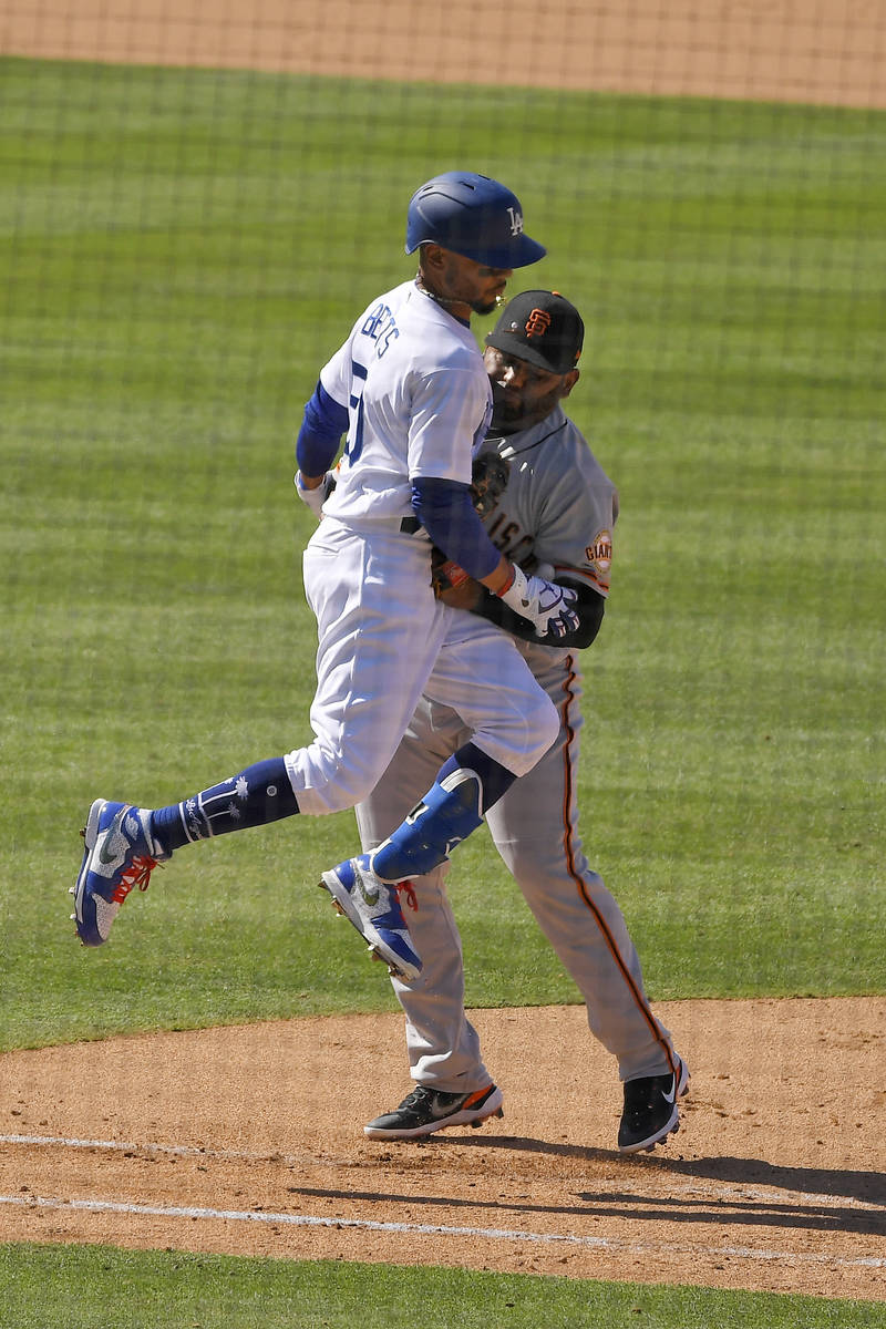 Los Angeles Dodgers' Mookie Betts, left, collides with San Francisco Giants first baseman Pablo ...
