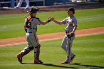 San Francisco Giants catcher Tyler Heineman, left, and relief pitcher Trevor Gott congratulate ...