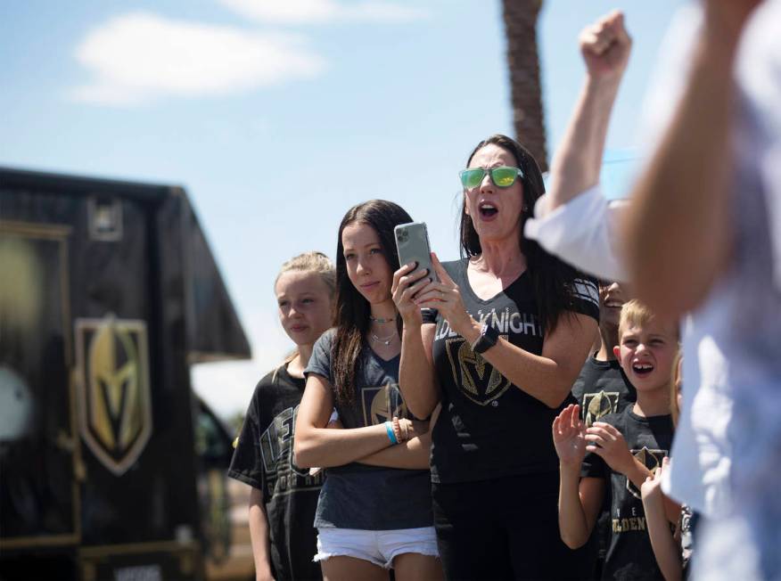 Fans wave at buses of the Golden Knights players as they leave for Canada as part of NHL's retu ...