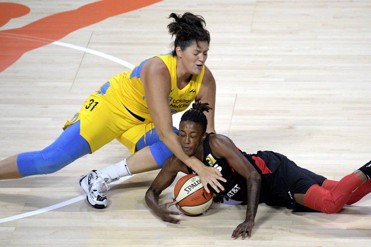 Las Vegas Aces guard Danielle Robinson, right, gains control of the ball in front of Chicago Sk ...