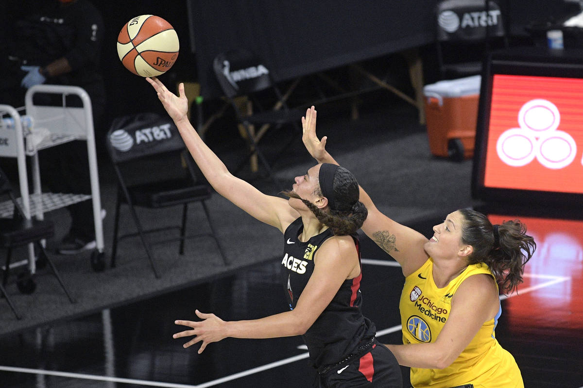 Las Vegas Aces forward Dearica Hamby, left, goes up to shoott in front of Chicago Sky center St ...