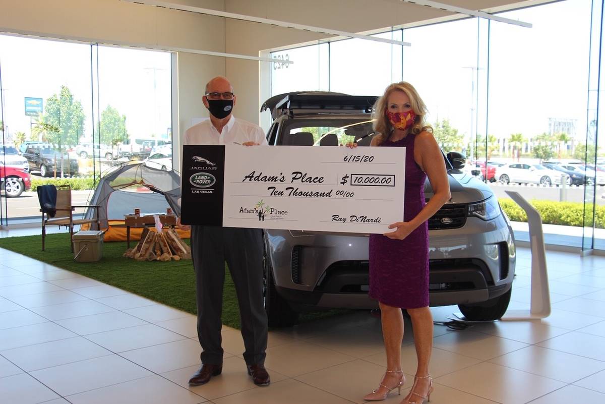 Jaguar Land Rover Las Vegas general manager Ray Dinardi presents check to Adam’s Place co-fou ...