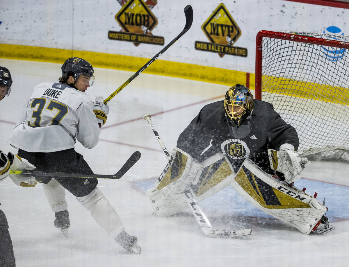 Vegas Golden Knights center Reid Duke (37, left) stops short of goaltender Marc-Andre Fleury ( ...