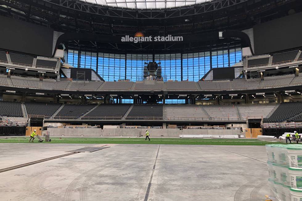 Crews installing the artificial turf that UNLV football will play its home games on in Allegian ...