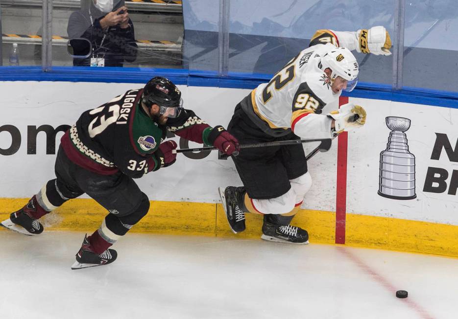 Arizona Coyotes' Alex Goligoski (33) hooks Vegas Golden Knights' Tomas Nosek (92) during the th ...