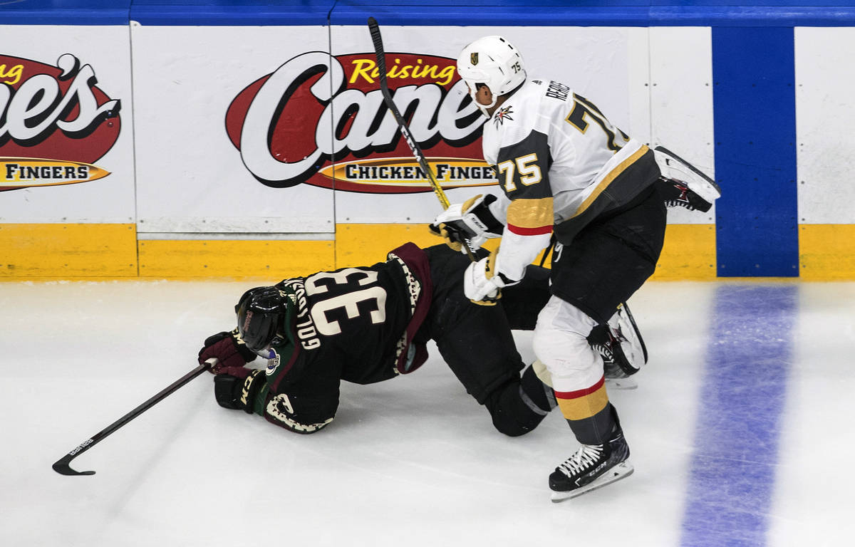 Arizona Coyotes' Alex Goligoski (33) is checked by Vegas Golden Knights' Ryan Reaves (75) durin ...