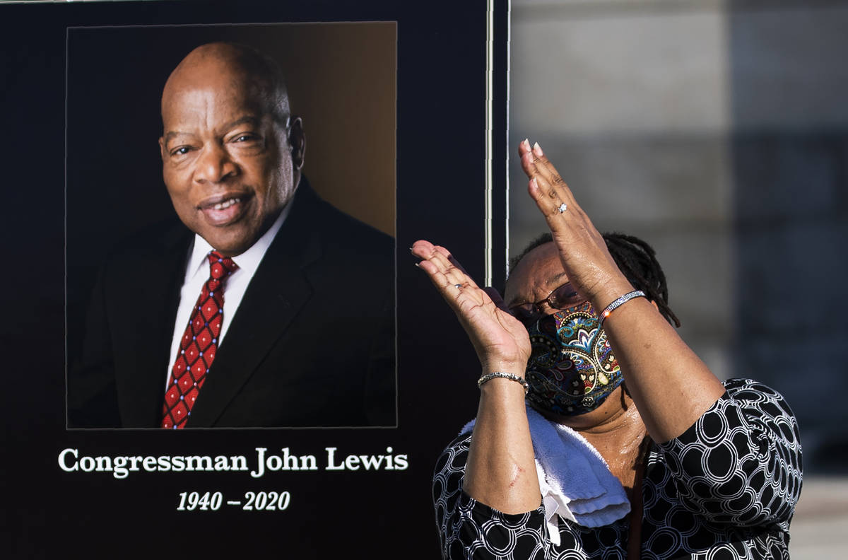 Jaquenette Ferguson from Oxon Hill, Md., gestures as she gets her picture taken beside a portra ...