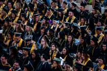 In this 2018, file photo, graduates sit and talk among each other at the start of Nevada State ...