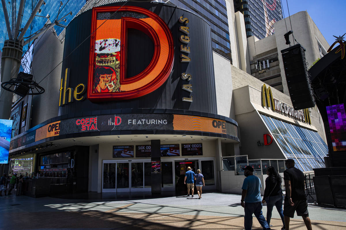 People walk outside of the D Las Vegas at the Fremont Street Experience in downtown Las Vegas o ...