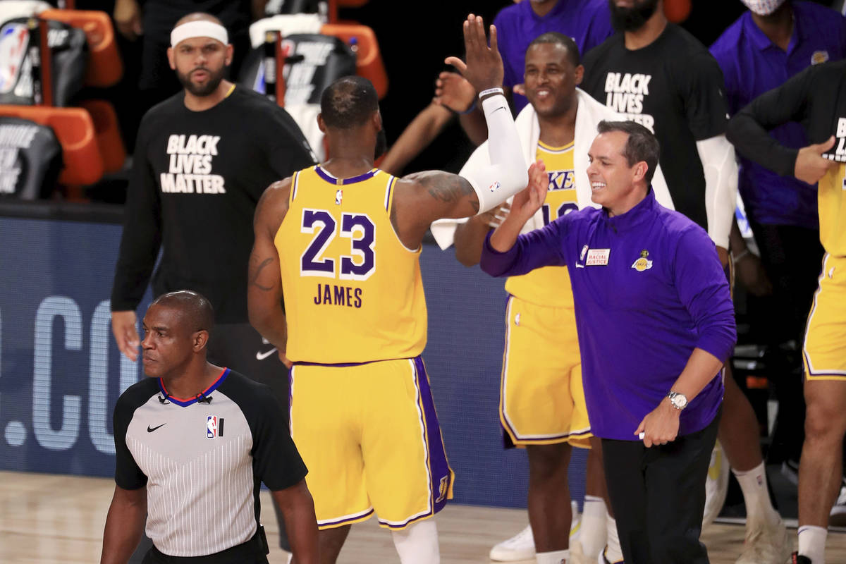 Los Angeles Lakers' LeBron James (23) celebrates with coach Frank Vogel after the Lakers defeat ...
