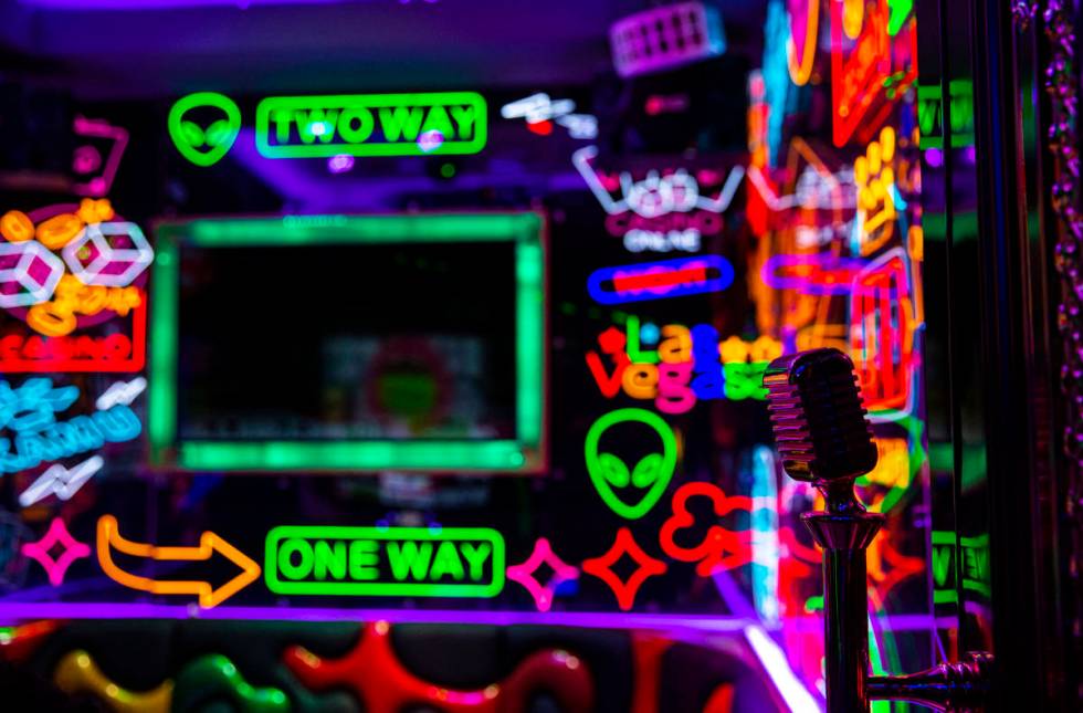A door handle featuring a microphone in a room filled with neon at Kamu Karaoke at the Grand Ca ...