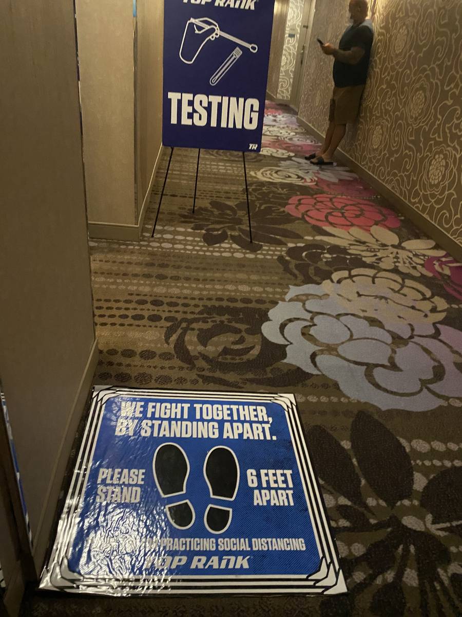 Signs are shown leading to the COVID-19 testing suite at MGM Conference Center on Monday, June ...